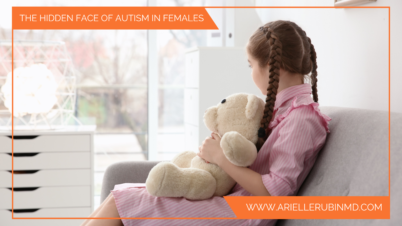 young autistic girl hugging stuffed teddy bear
